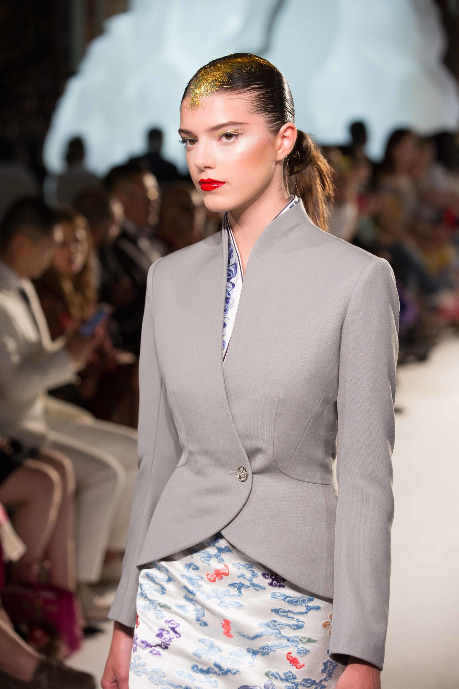 a woman in a grey suit
