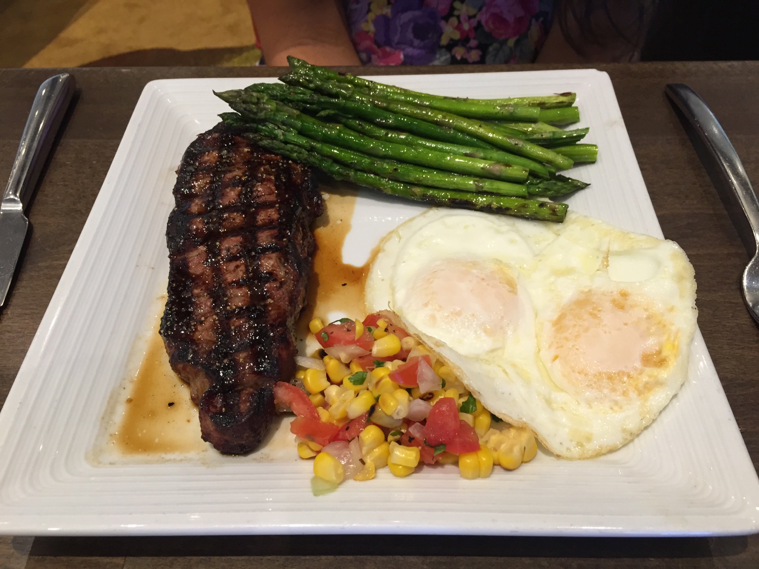 a plate of food with eggs and asparagus