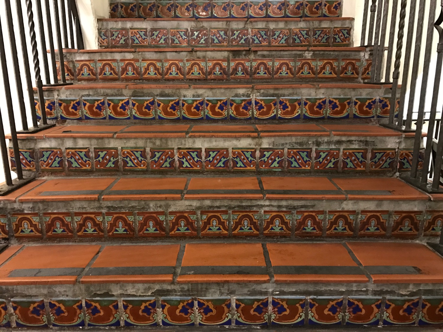 a staircase with tile on the side