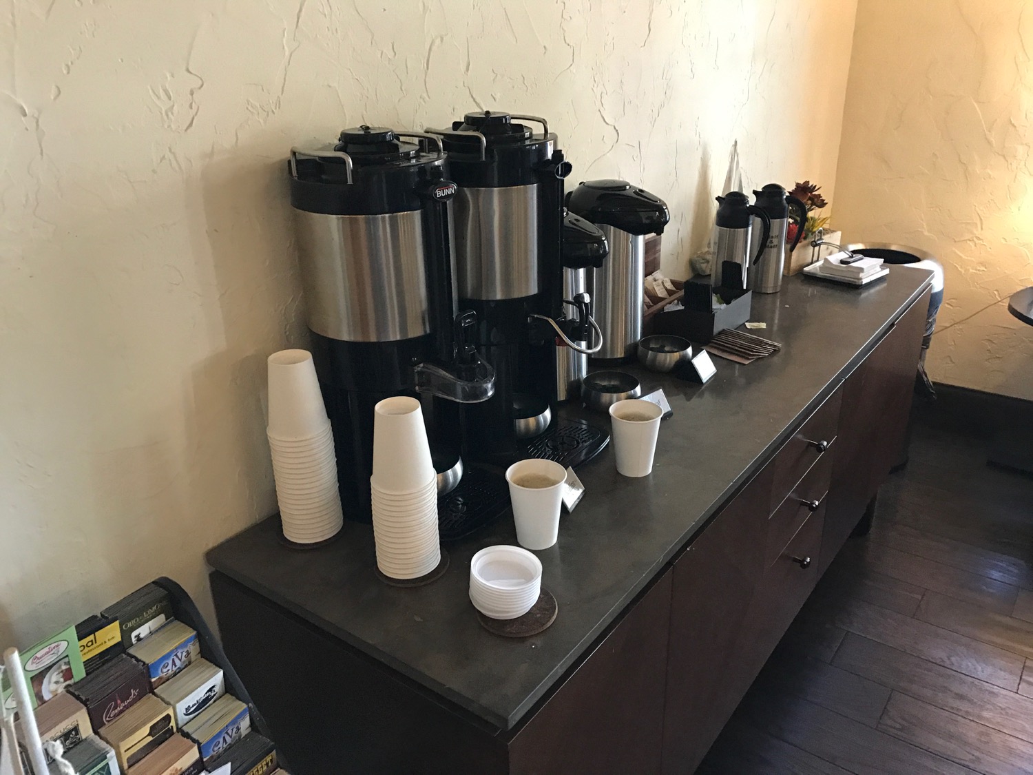 a coffee maker and cups on a counter