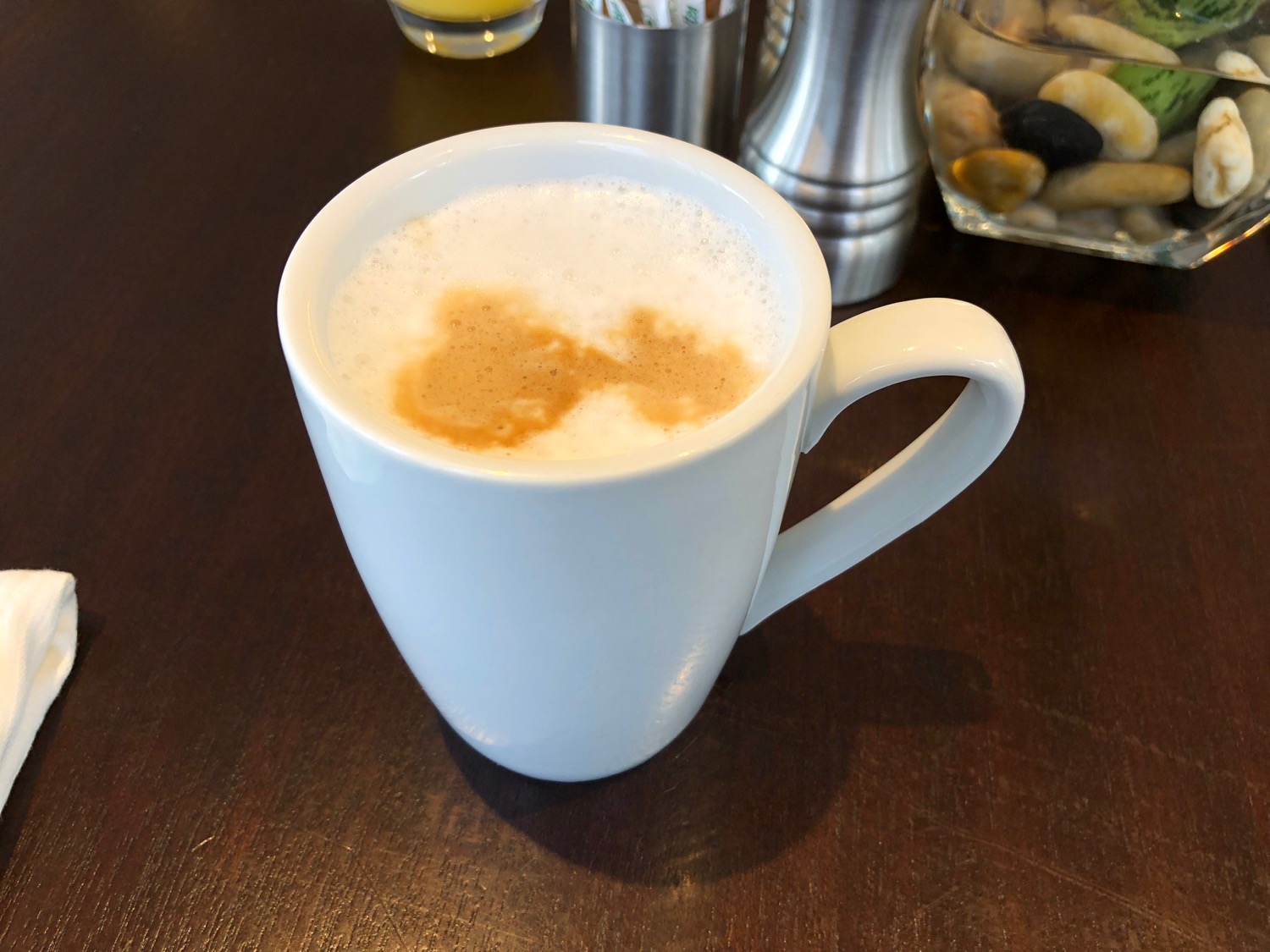 a white mug with foamy liquid in it