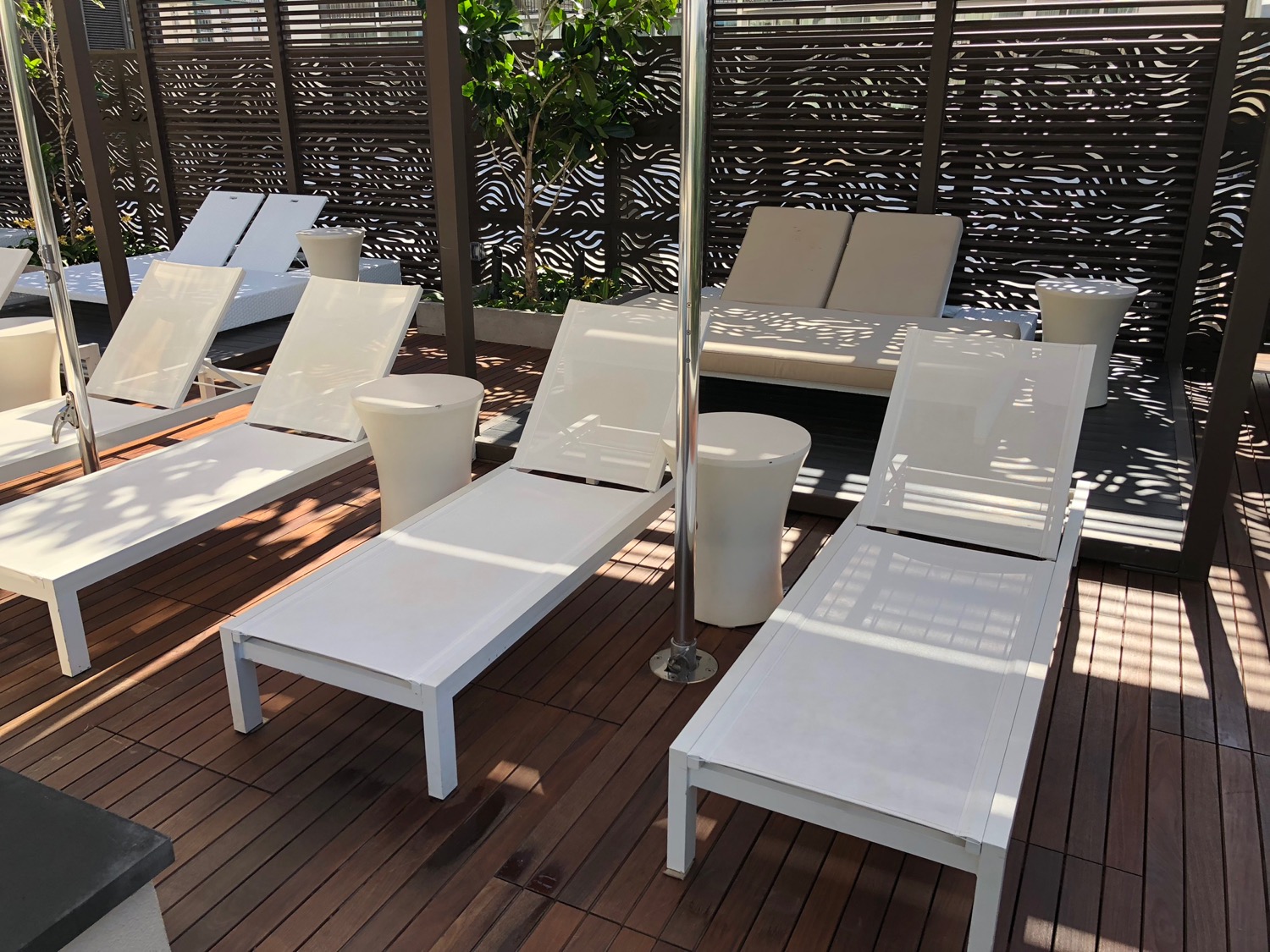 a group of white lounge chairs on a deck