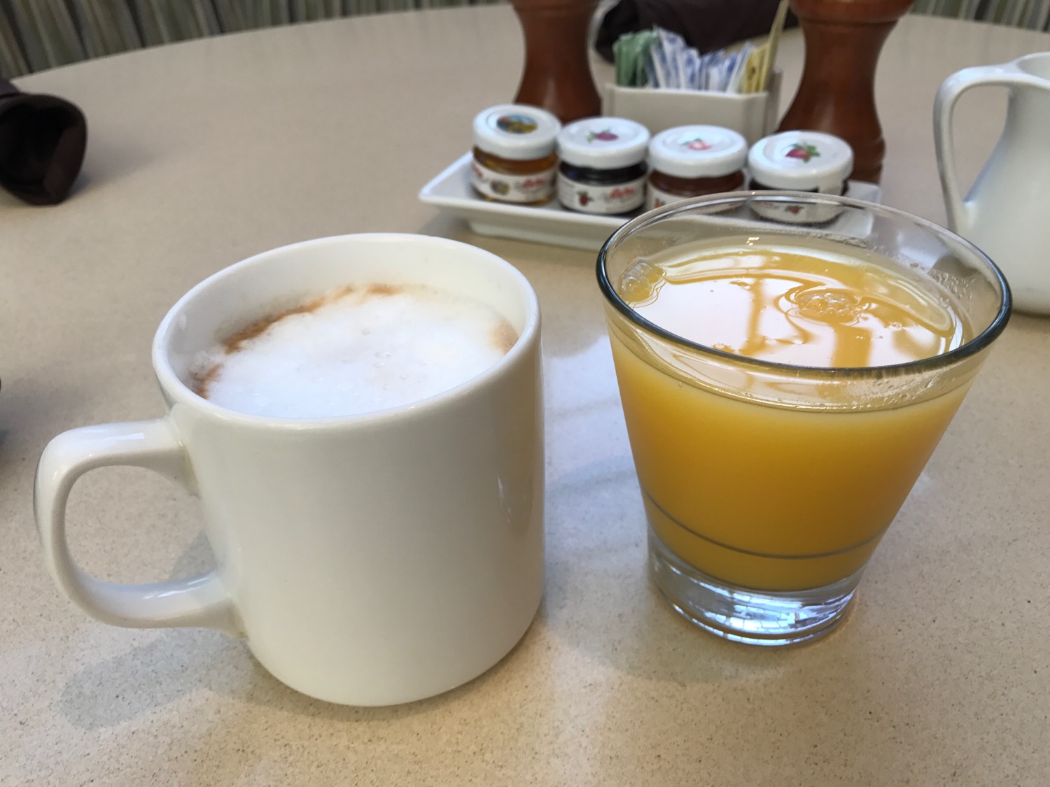 a coffee mug and a glass of orange juice on a table