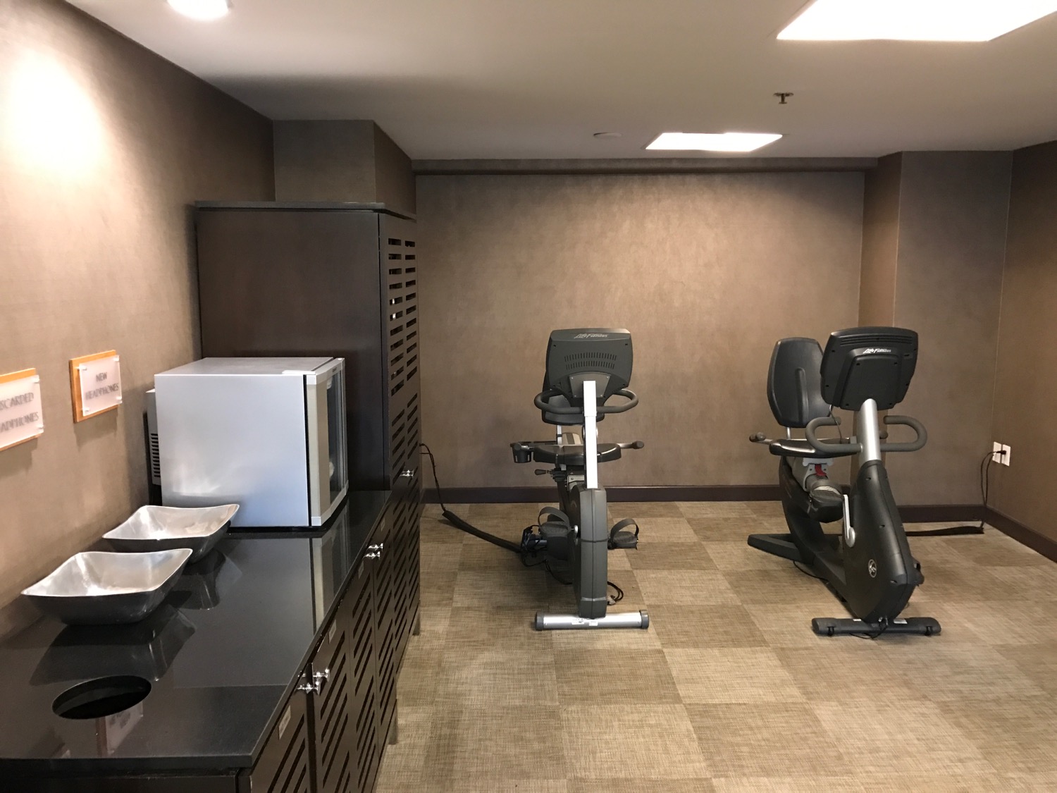 a room with exercise bikes and a microwave