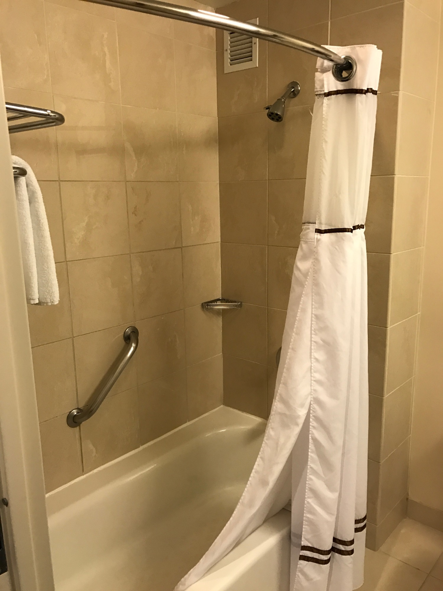 a shower with a white curtain