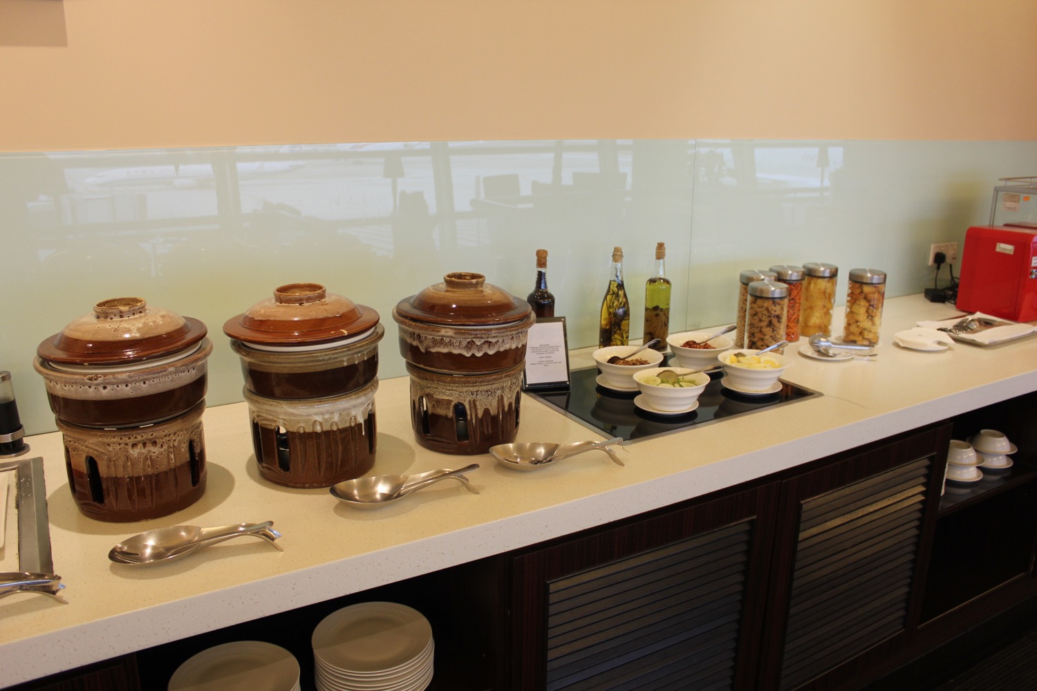 a buffet table with food and utensils