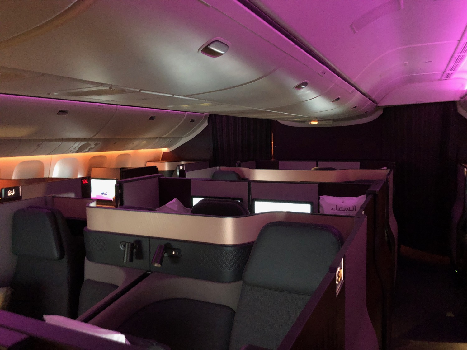 a cabin of an airplane with purple lights