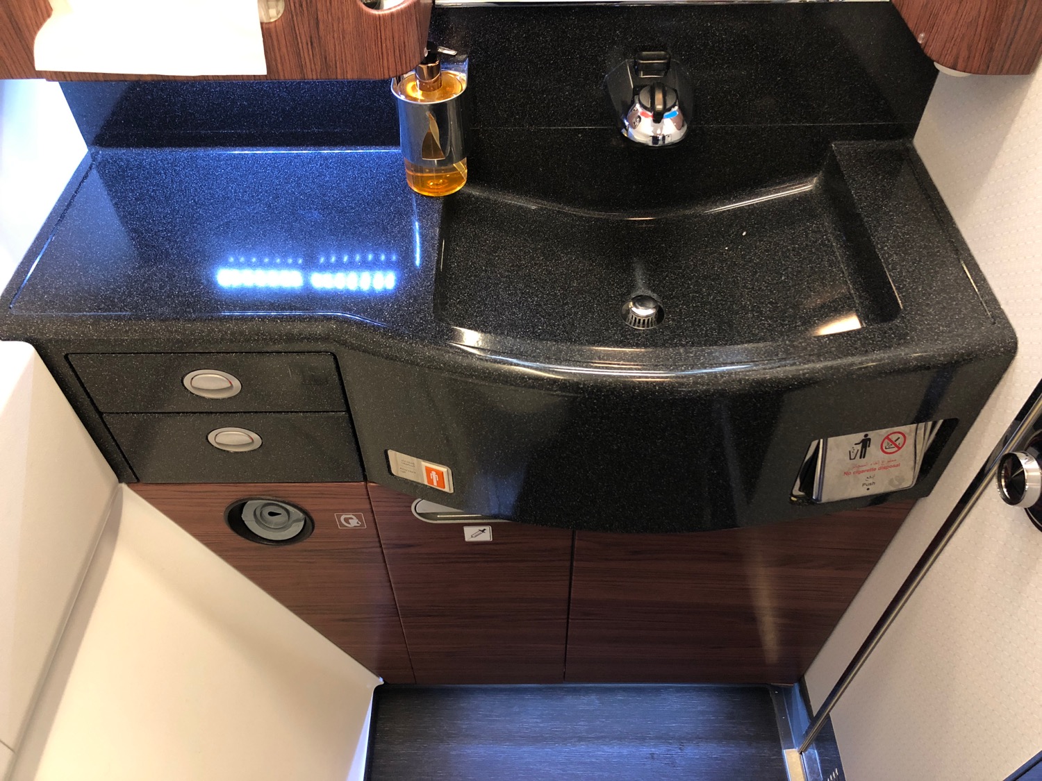 a sink with a faucet and a bottle on the counter