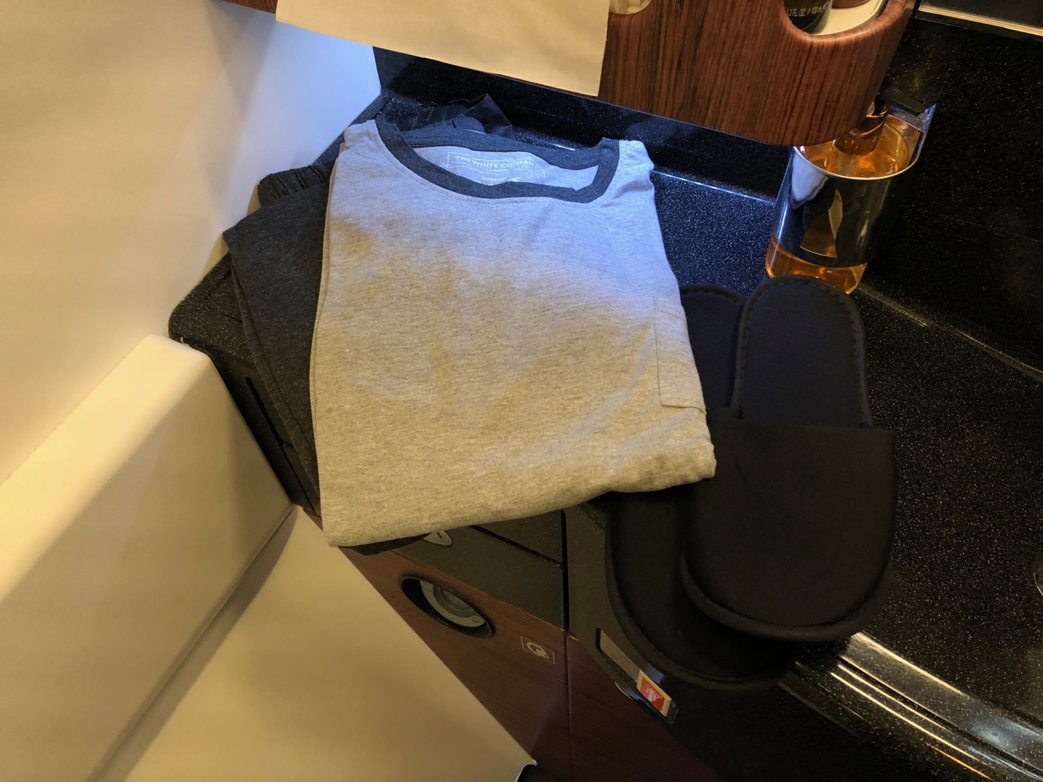 a grey shirt and slippers on a counter