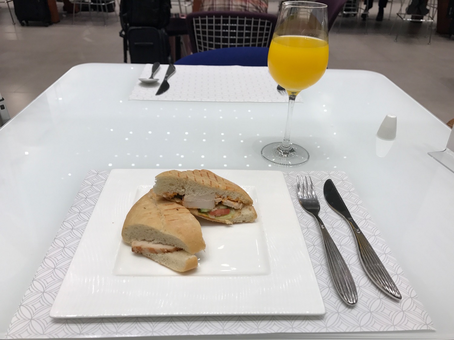 a plate of sandwiches and a glass of juice