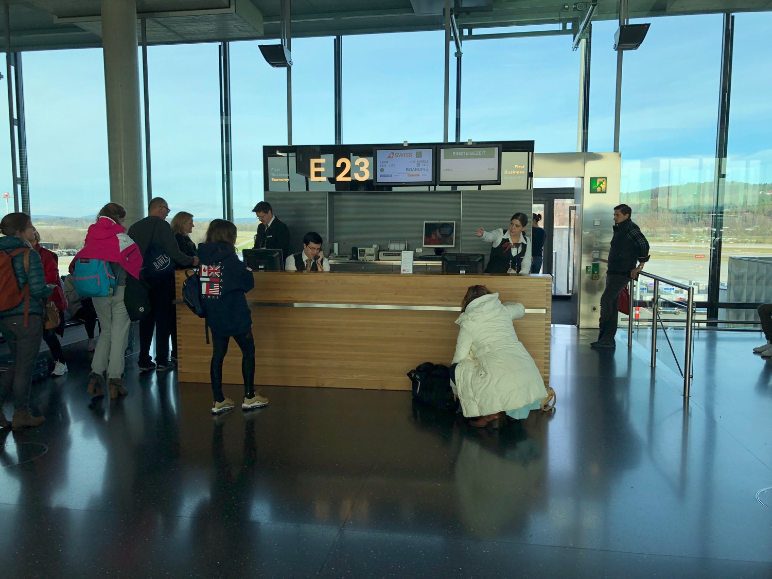people standing around a counter in a building