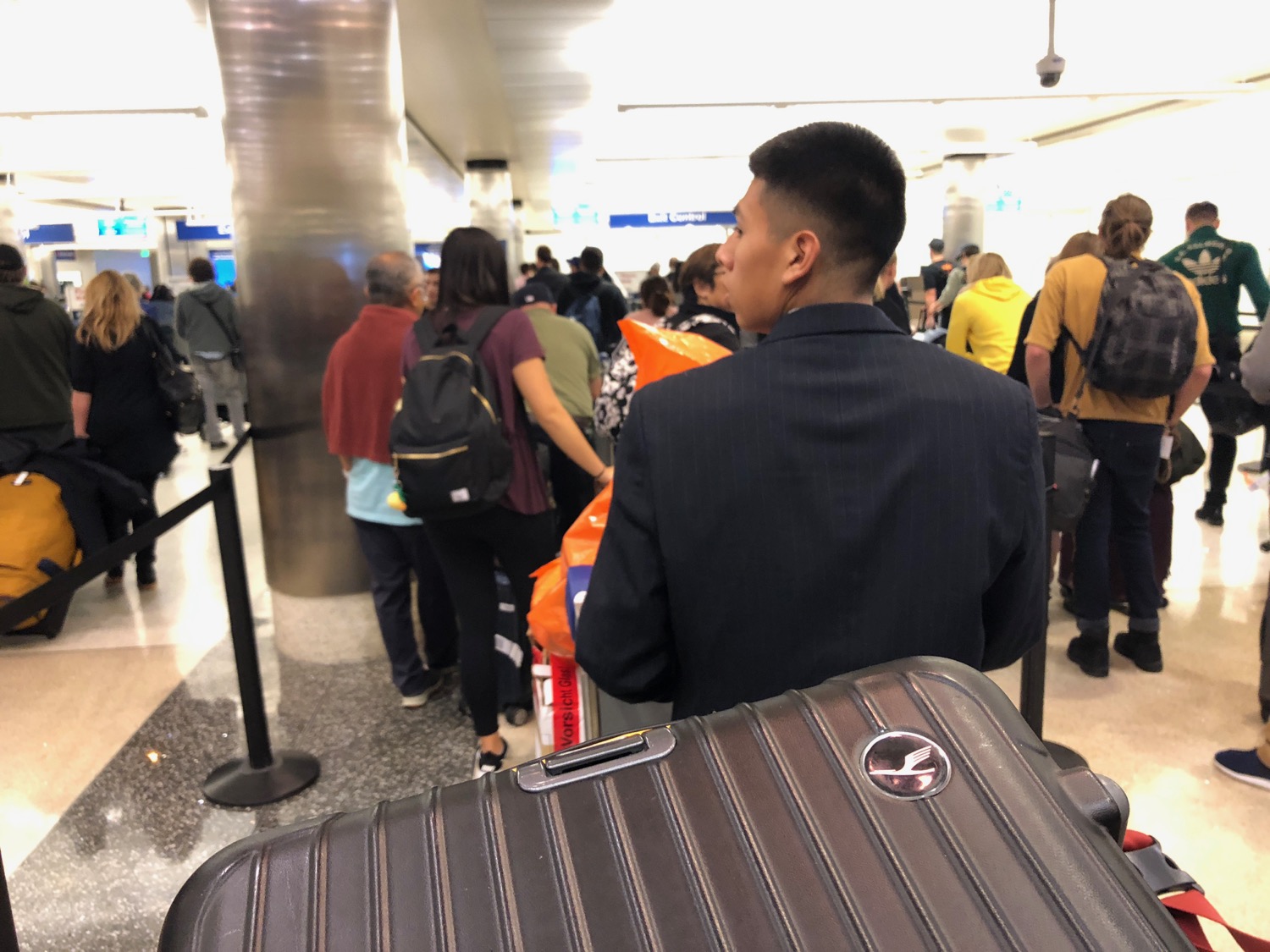 a man with a suitcase in a crowded airport