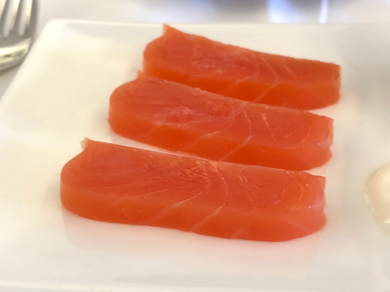 a group of slices of salmon on a plate