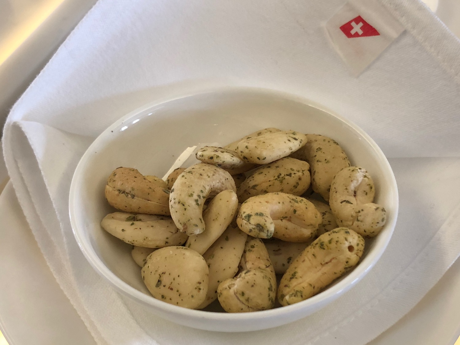 a bowl of cashews on a napkin