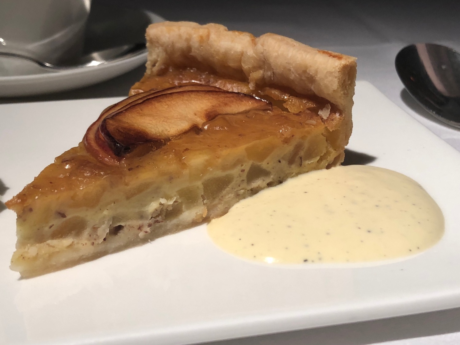 a slice of pie on a plate with sauce