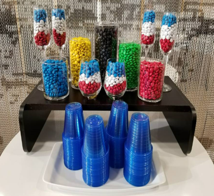 a group of glasses filled with candy
