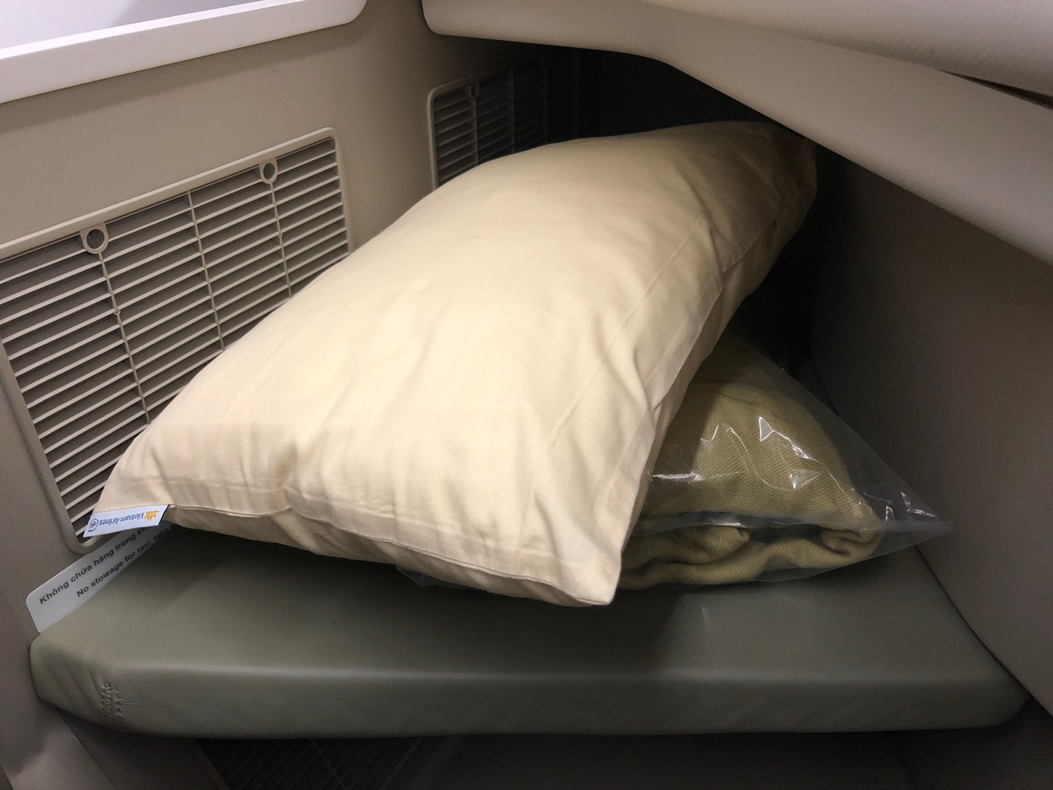 a pillow and a bag on a seat