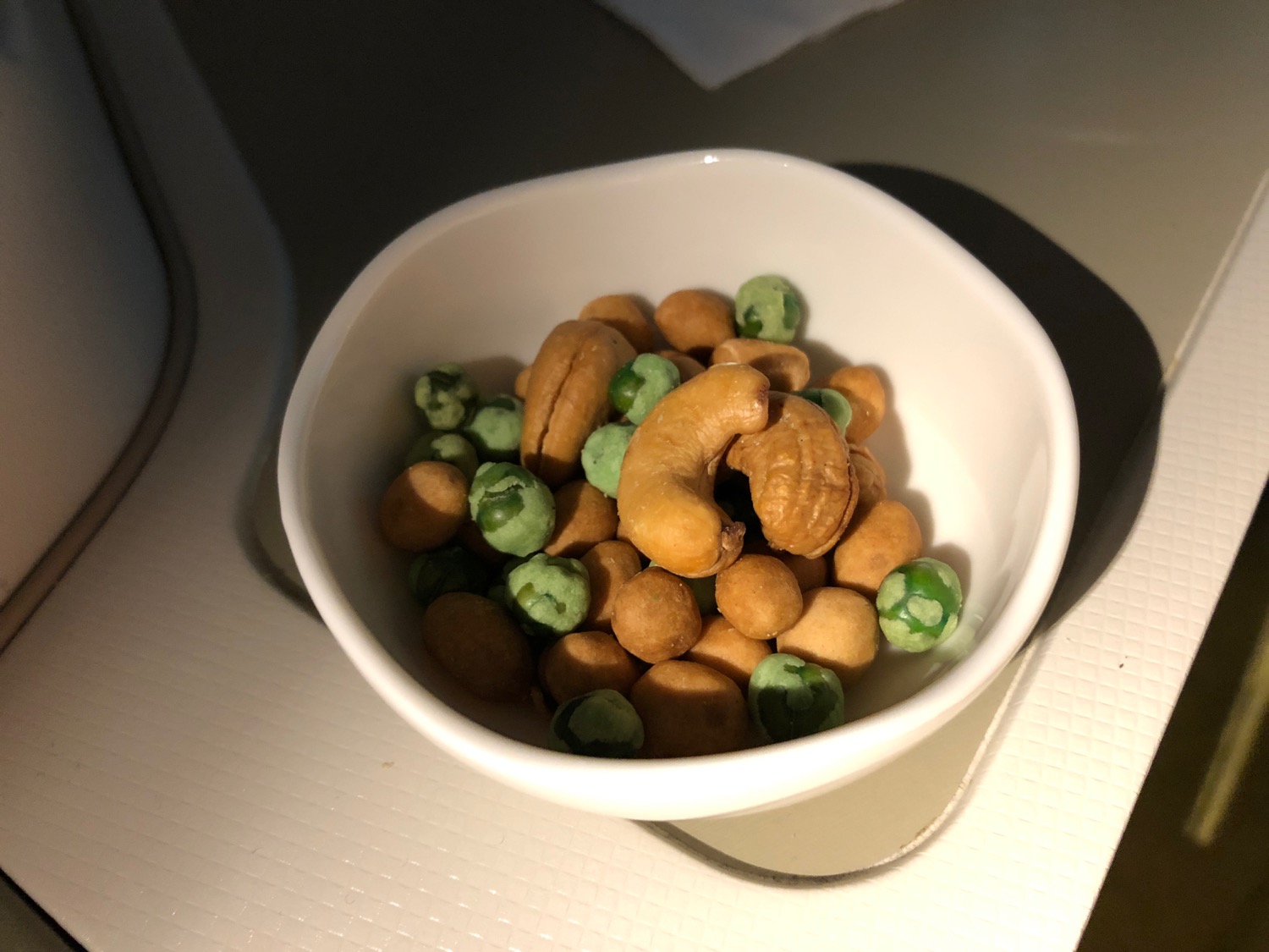 a bowl of nuts and peas