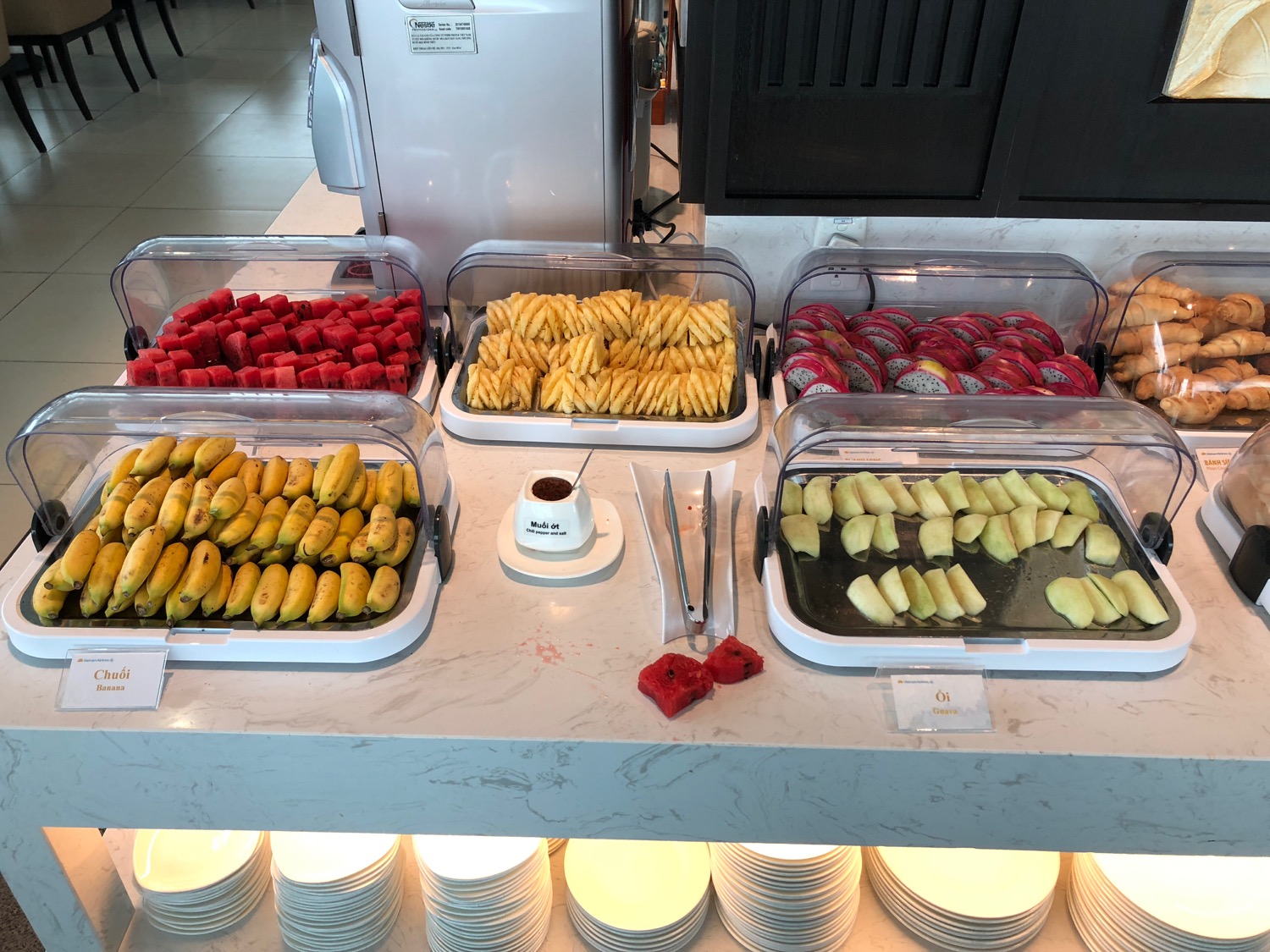 a buffet table with trays of fruit and vegetables