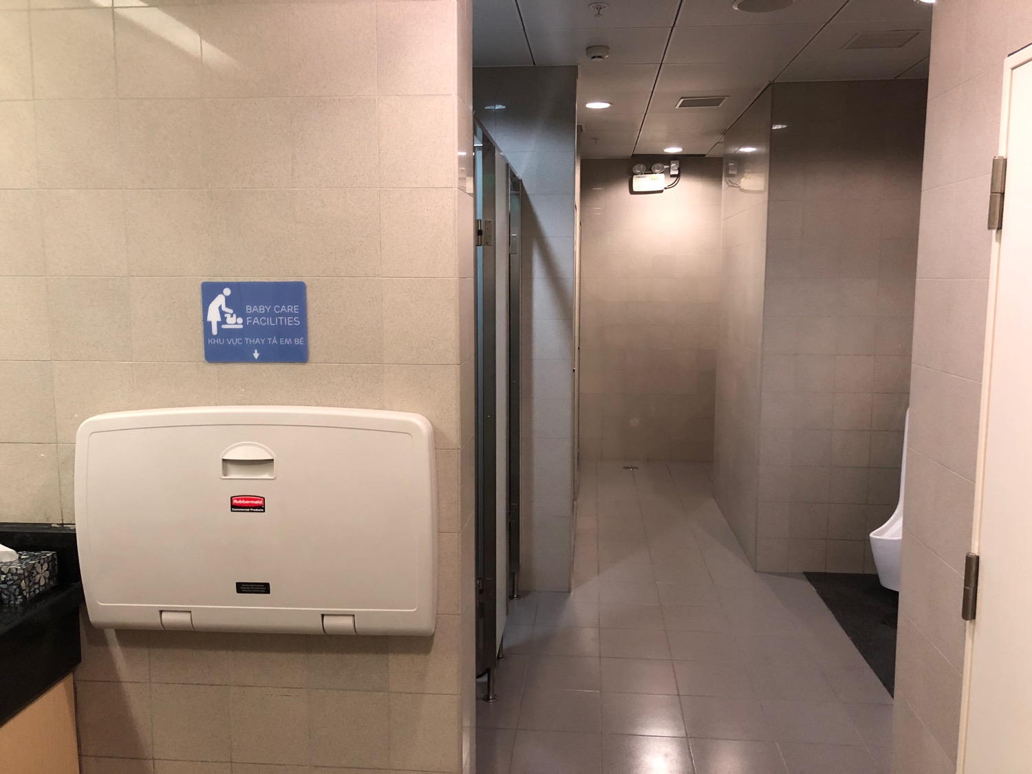 a bathroom with a toilet and a sign