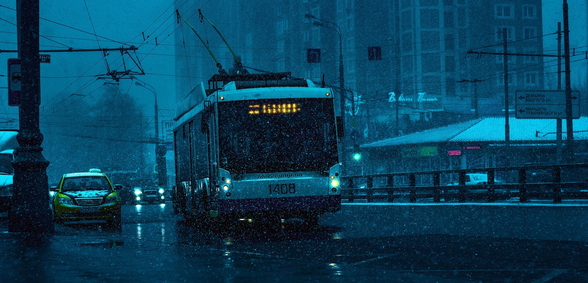 a bus driving down a street in the rain