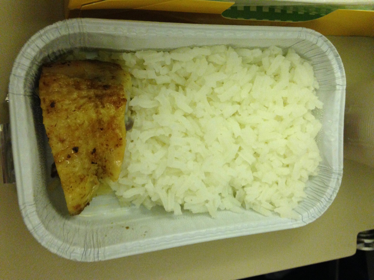 a plate of food with a piece of meat and rice