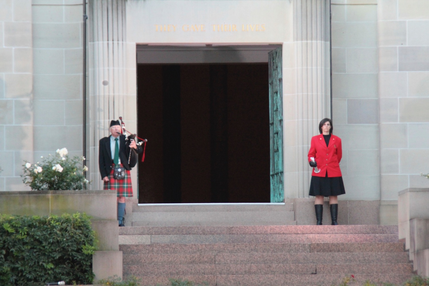 a man and woman playing bagpipes outside a building