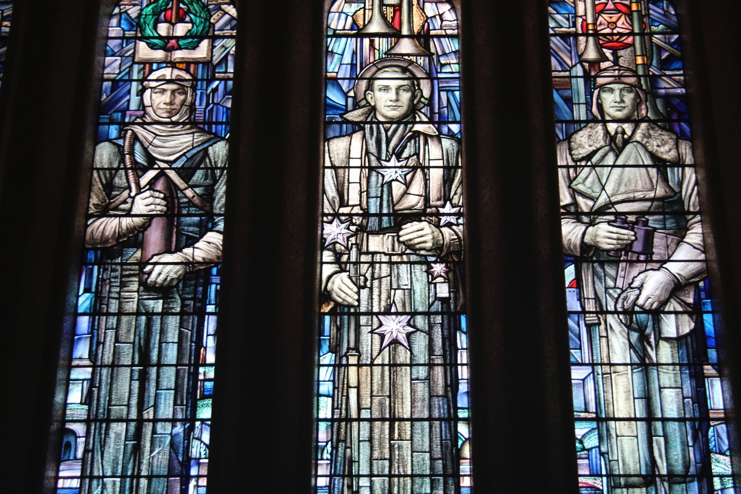 a stained glass window with a group of men