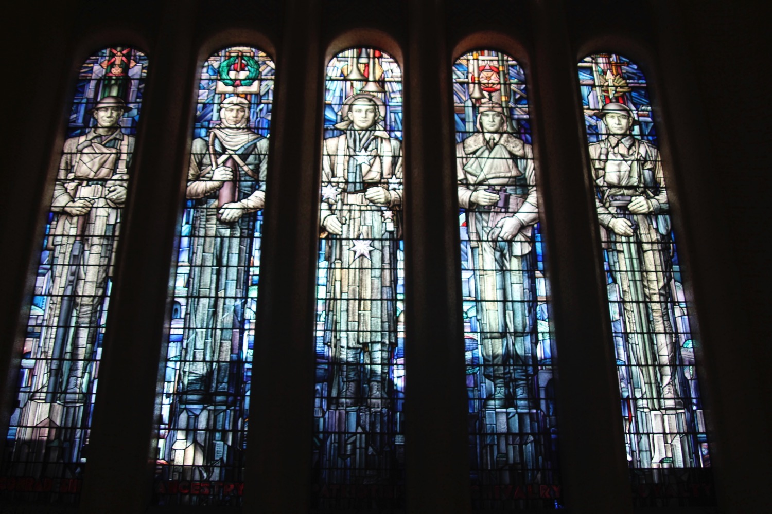 a stained glass window with a group of people in the background