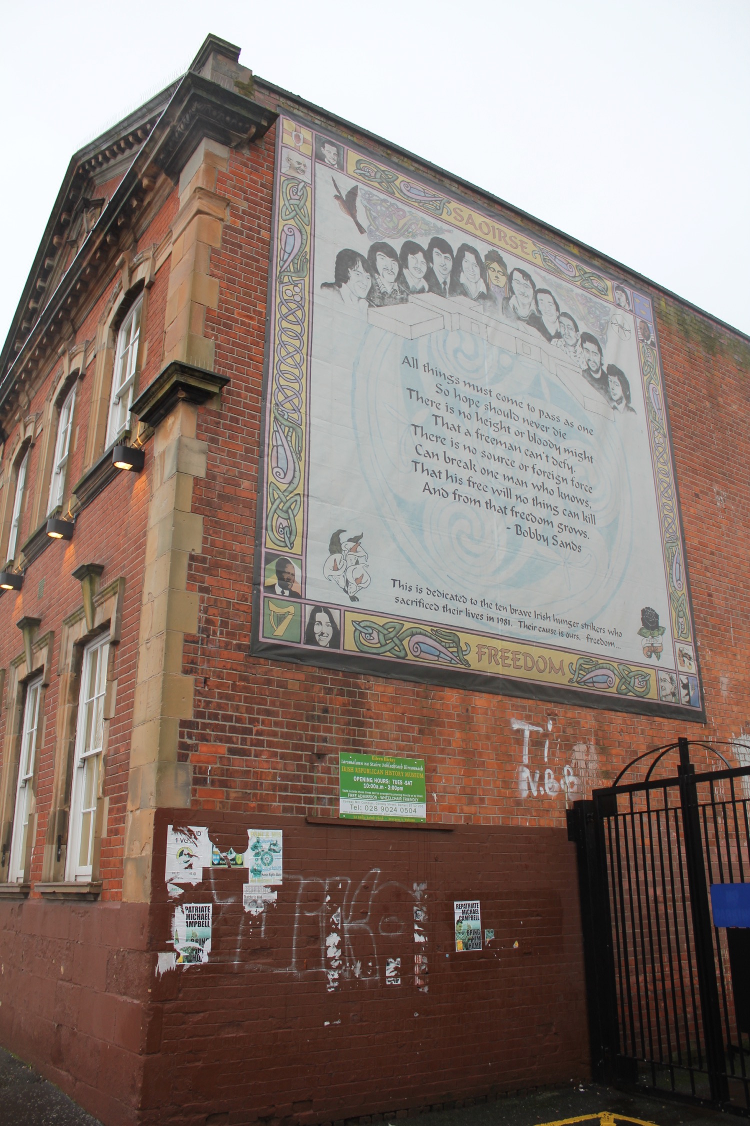 a brick building with a large mural on the side