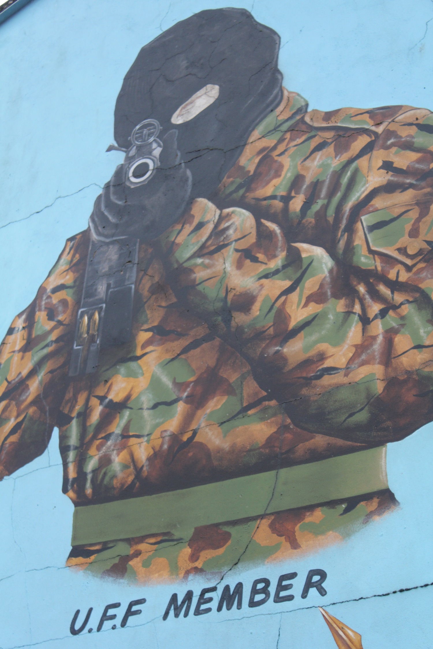 a mural of a soldier with a gun on a wall
