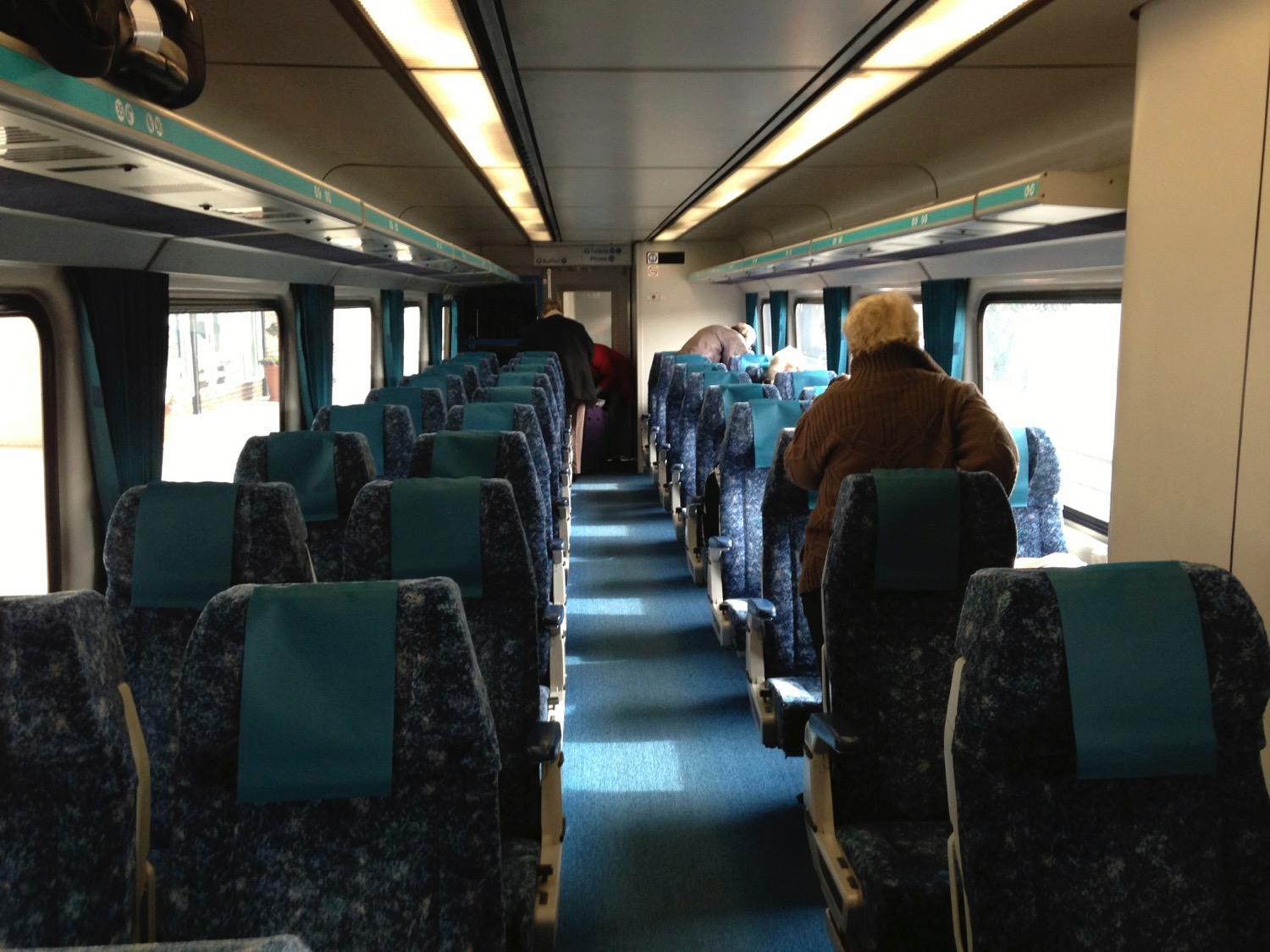 a group of people sitting on a train