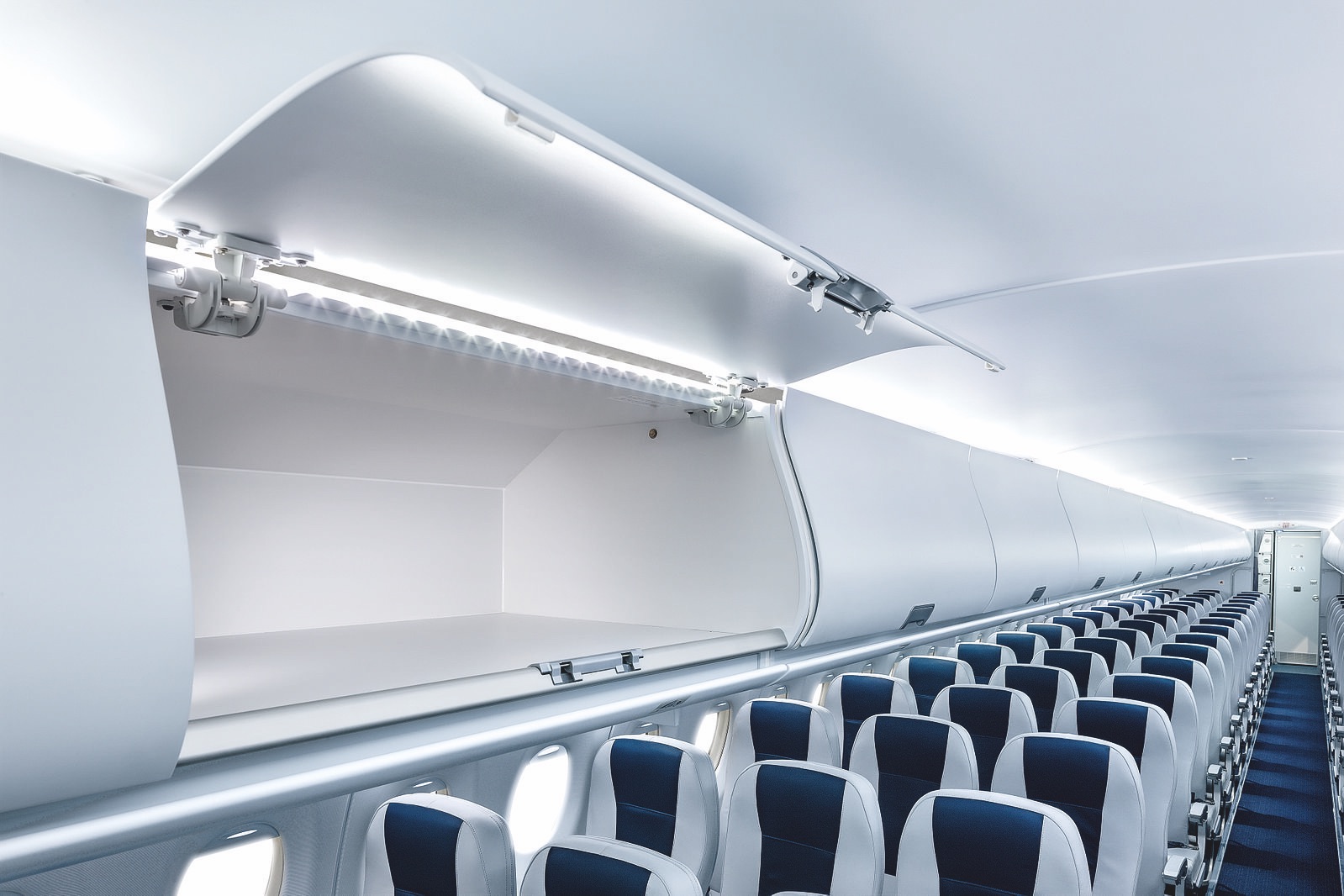 an airplane with an open shelf with blue and white seats