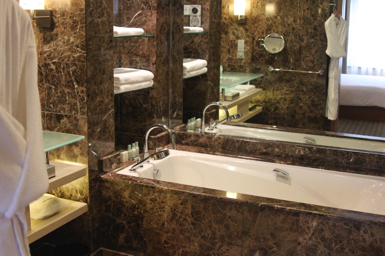 a bathroom with marble walls and a bathtub