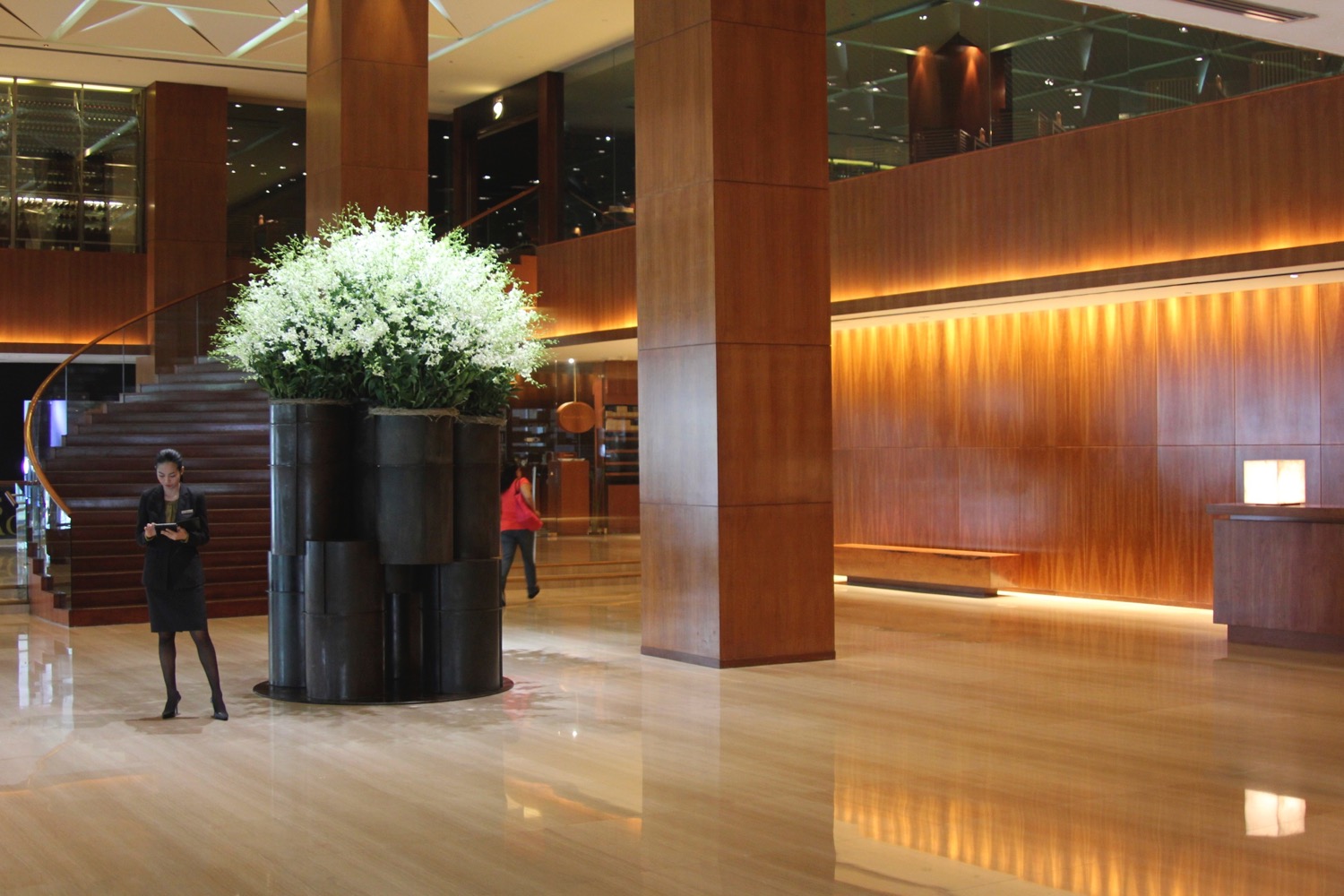 a large planter with white flowers in a large room