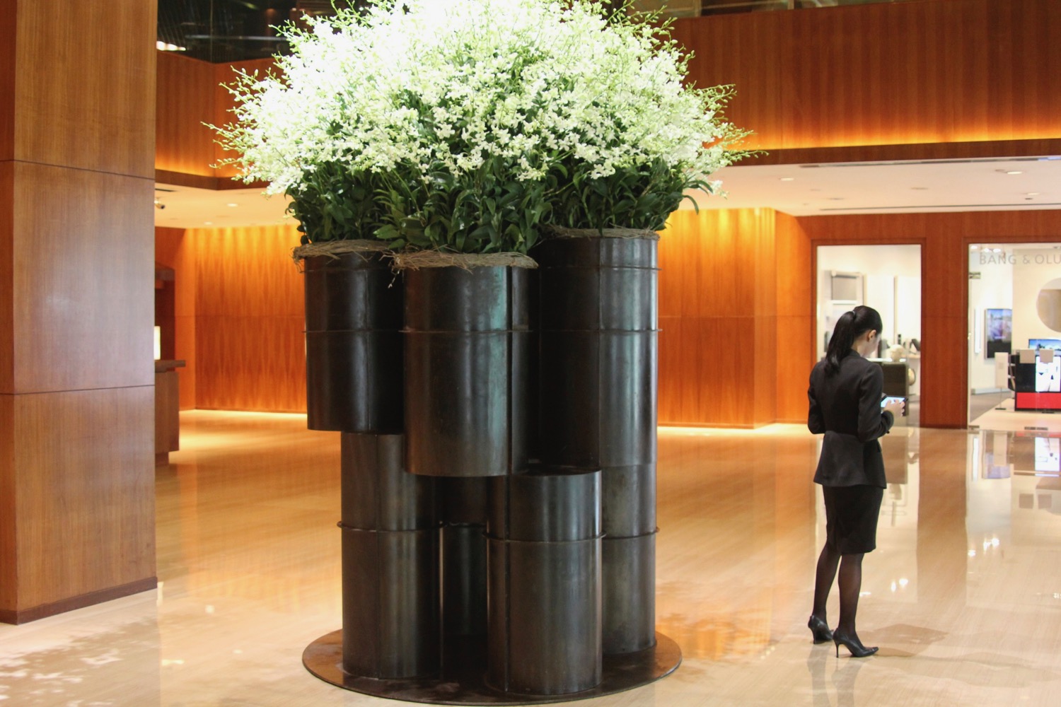 a woman standing in front of a large planter