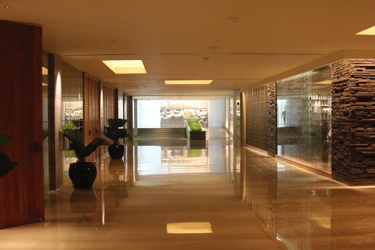 a hallway with a large glass wall