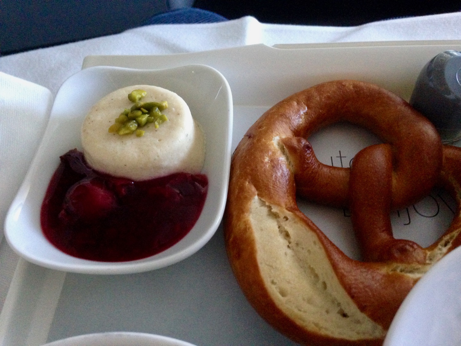 a pretzel and dessert on a tray
