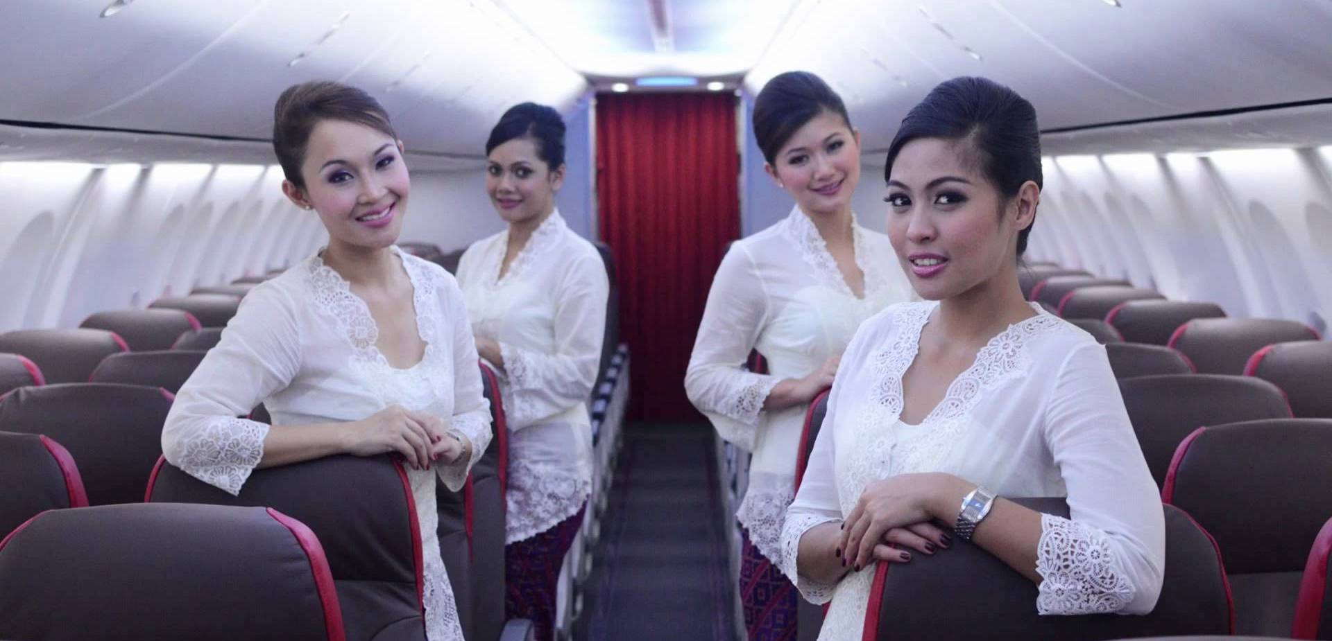 a group of women in white shirts on a plane