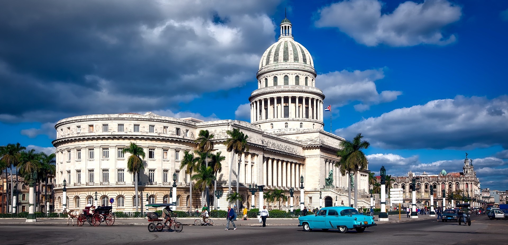 El Capitolio with a dome and palm trees