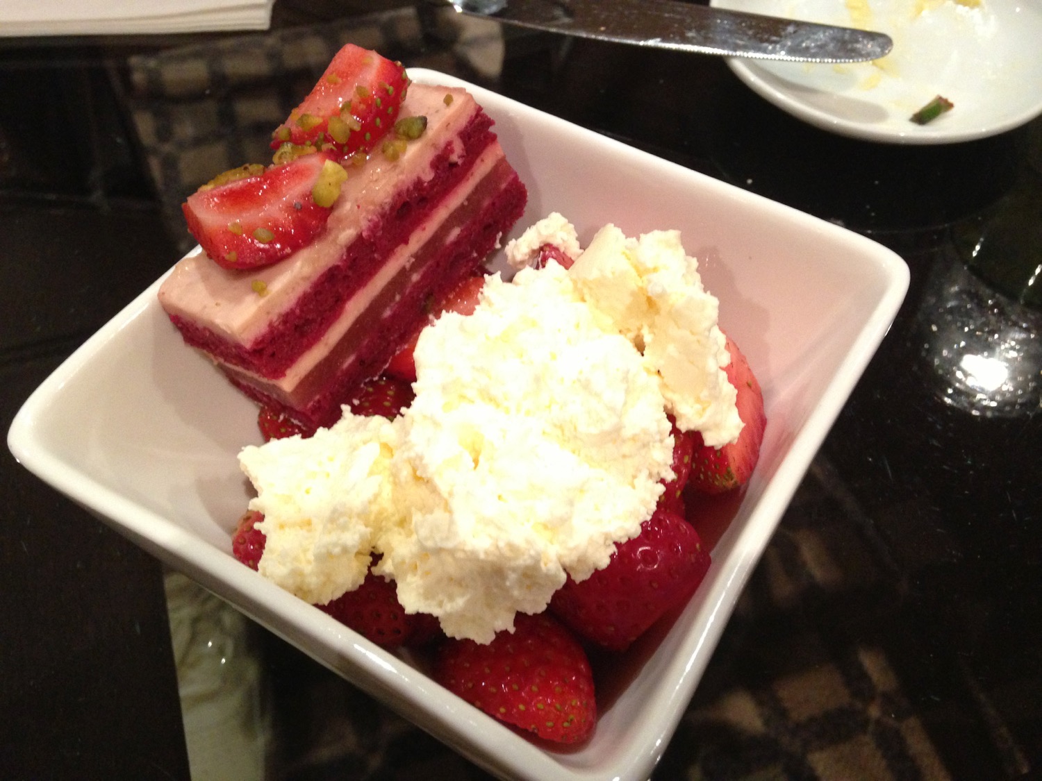 a bowl of dessert with strawberries and cake
