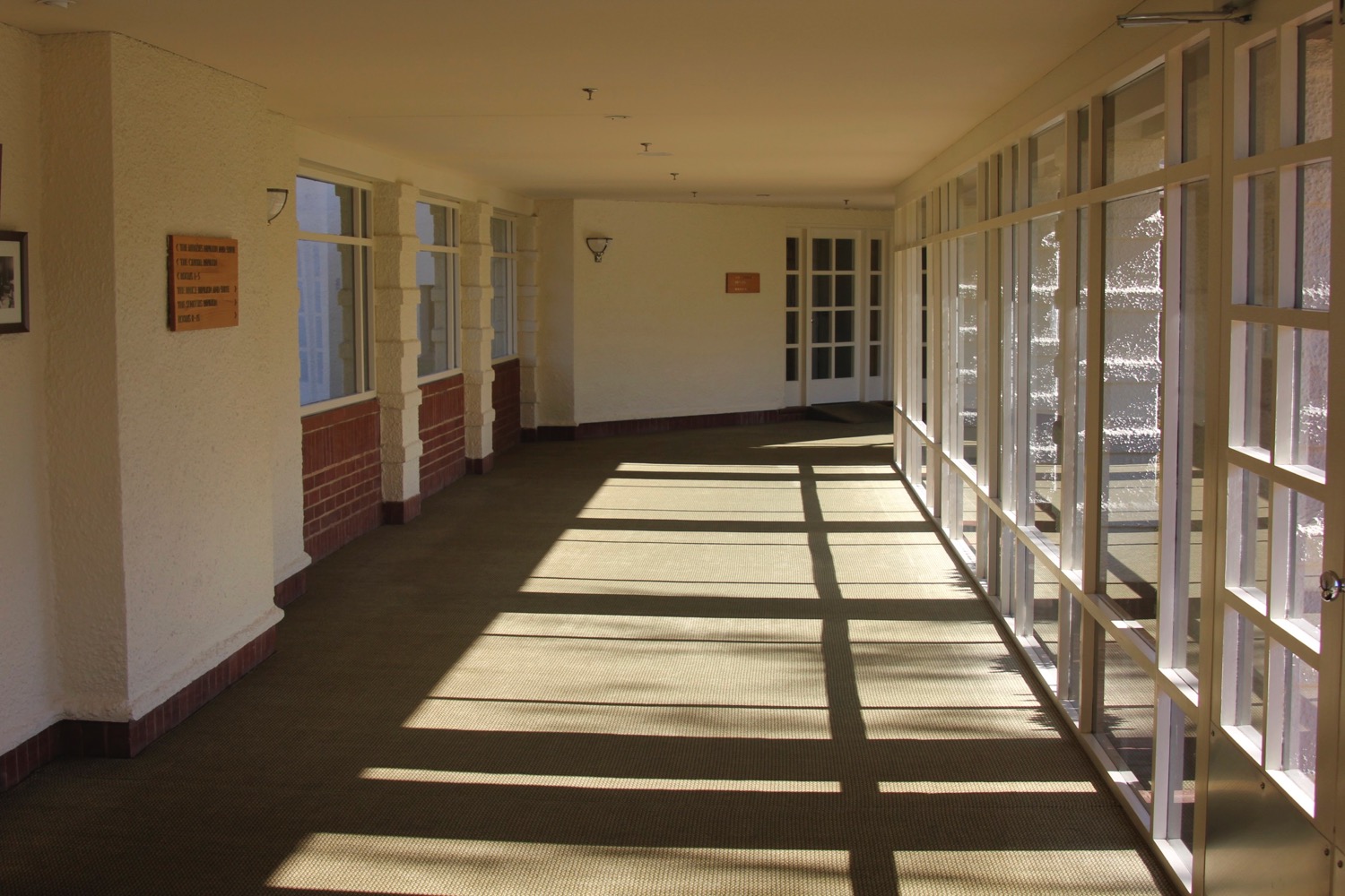 a hallway with windows and a sign