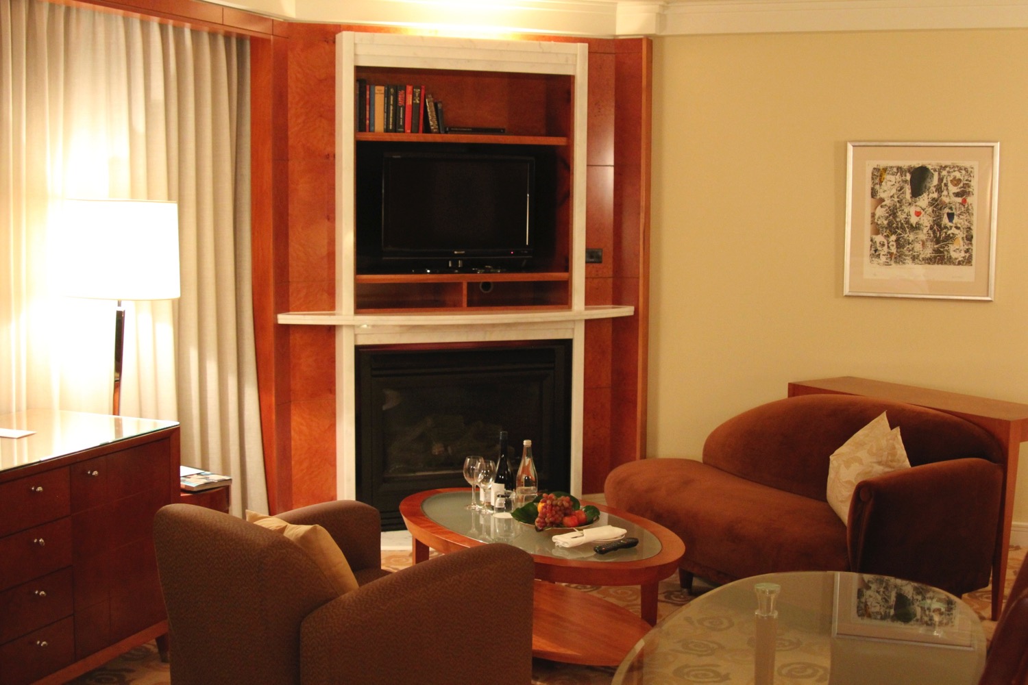 a living room with a fireplace and a tv