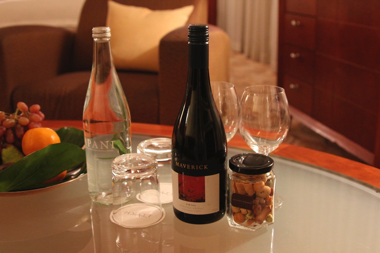 a bottle and glasses on a table