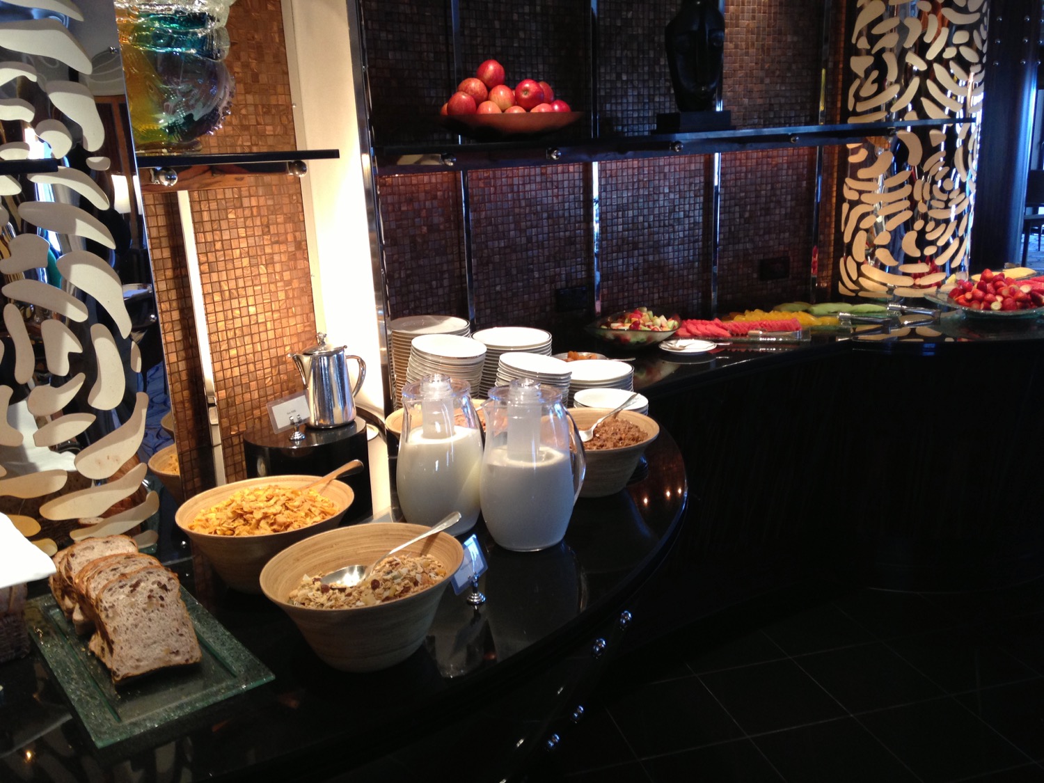 a breakfast buffet with cereals and milk