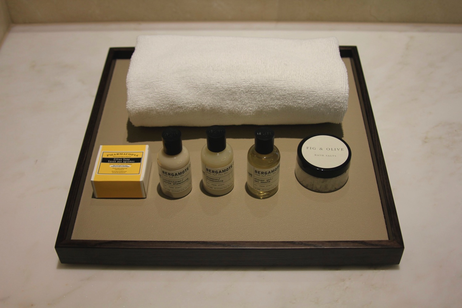 a group of small bottles and a towel on a tray