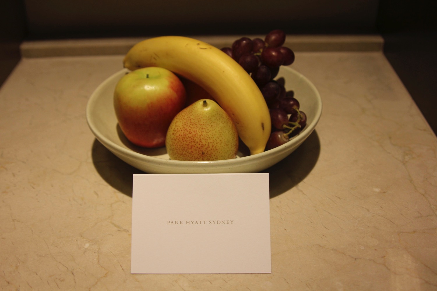 a bowl of fruit with a card