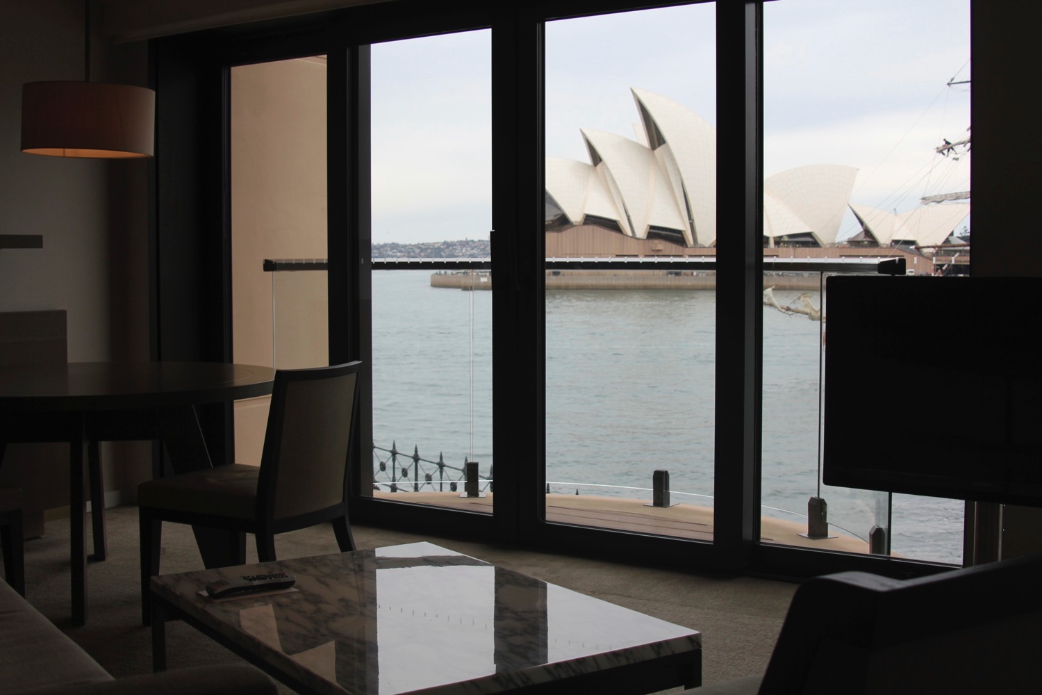 a room with a view of the opera house and water