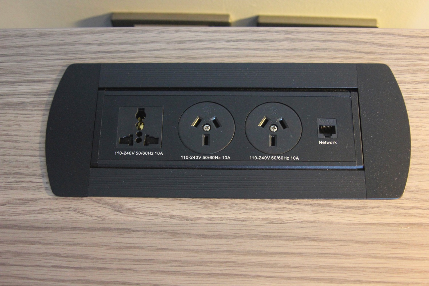 a black rectangular outlet with two plugs