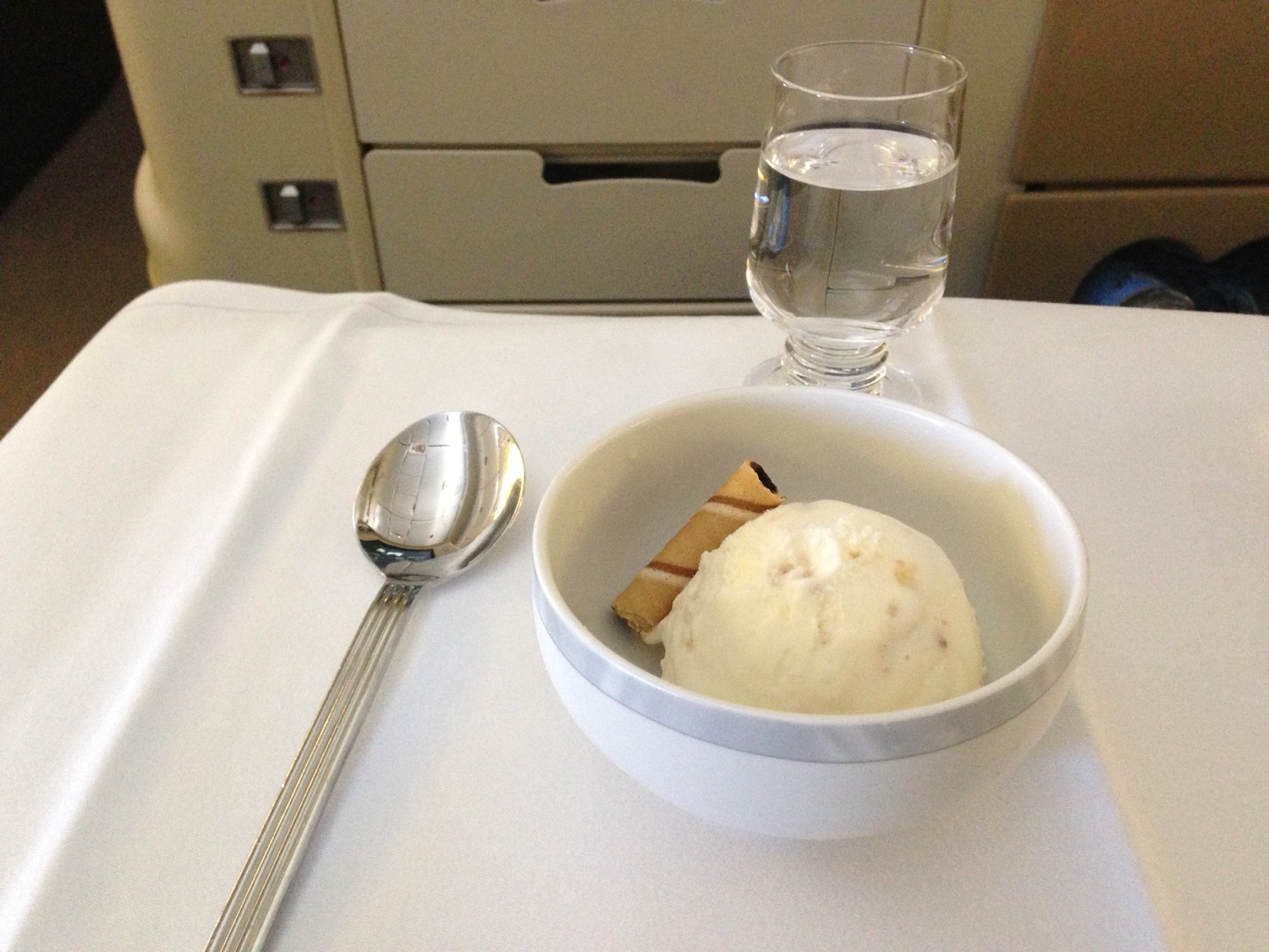 a bowl of ice cream and a glass of water